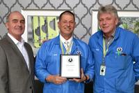 Libra Industries CEO Rod Howell presenting the service award to Bob Thibodeau.
